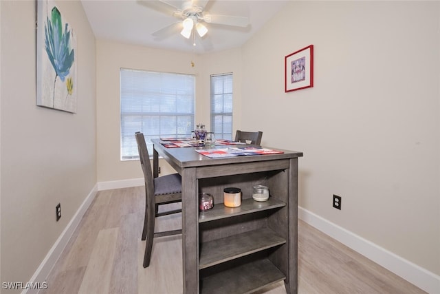 dining space with ceiling fan, a healthy amount of sunlight, and light wood-type flooring