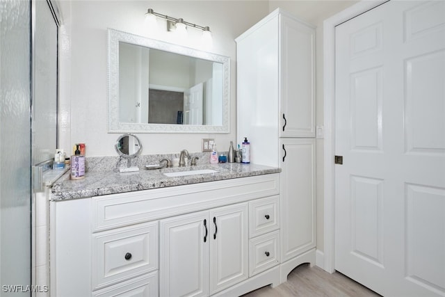 bathroom featuring hardwood / wood-style floors and vanity