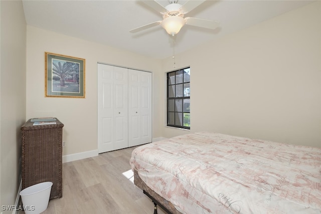 bedroom featuring ceiling fan, a closet, and light hardwood / wood-style flooring