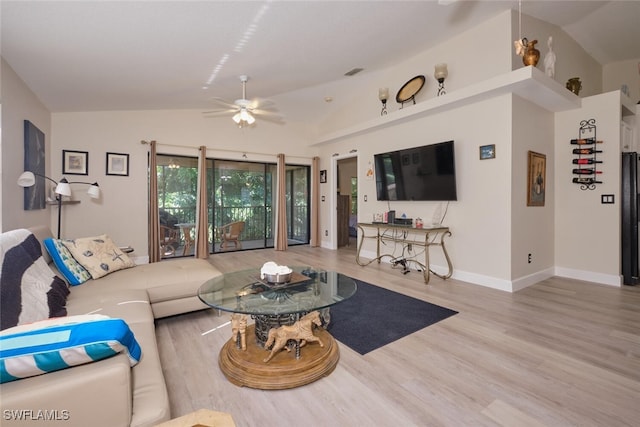 living room with vaulted ceiling, ceiling fan, and light hardwood / wood-style floors