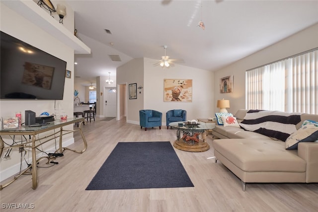 living room with ceiling fan, vaulted ceiling, and light wood-type flooring