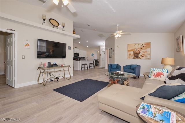 living room with ceiling fan, light hardwood / wood-style flooring, and vaulted ceiling