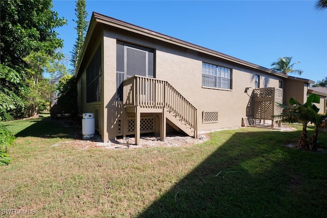 rear view of property with a yard