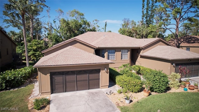 view of front of house with a garage and a front lawn