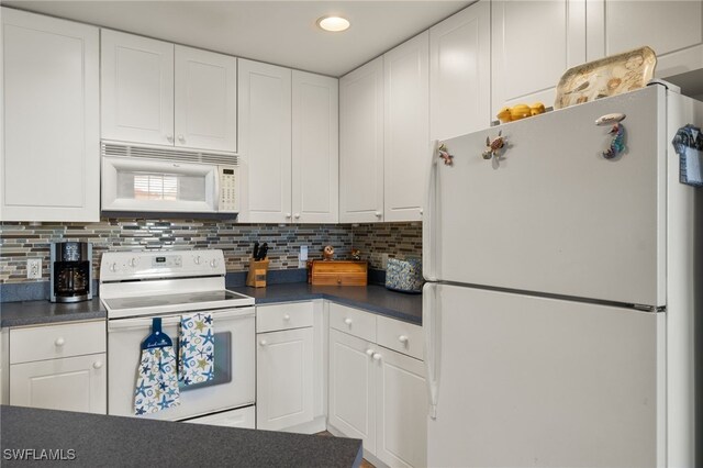 kitchen featuring dark countertops, white appliances, white cabinetry, and backsplash