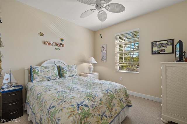 carpeted bedroom with a ceiling fan and baseboards