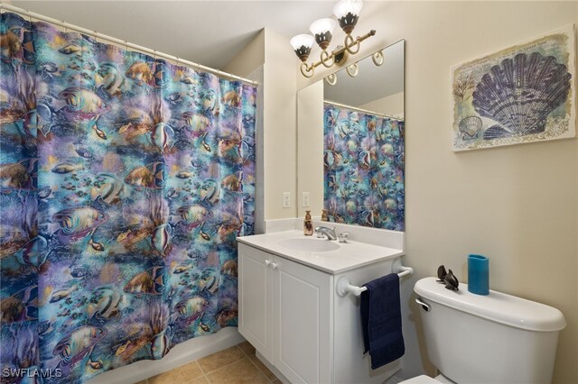 bathroom with a shower with shower curtain, vanity, toilet, and tile patterned floors