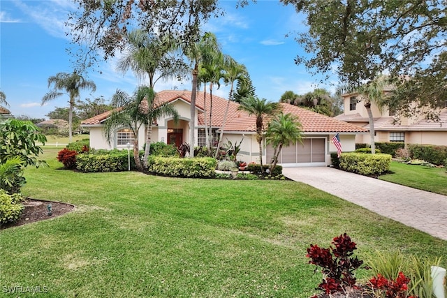 mediterranean / spanish-style home with a front lawn and a garage