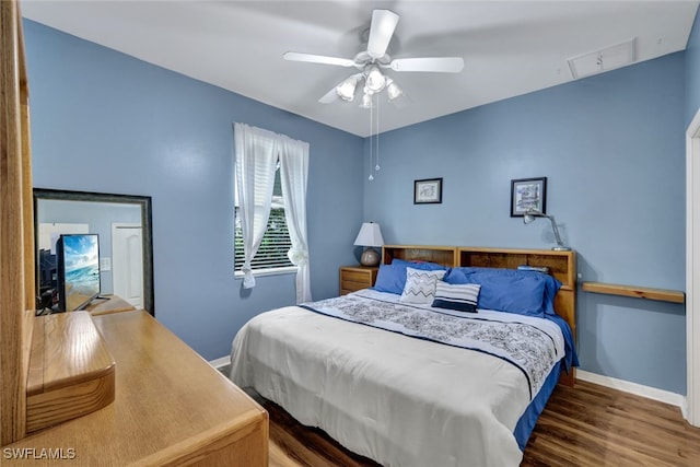 bedroom with ceiling fan and hardwood / wood-style floors