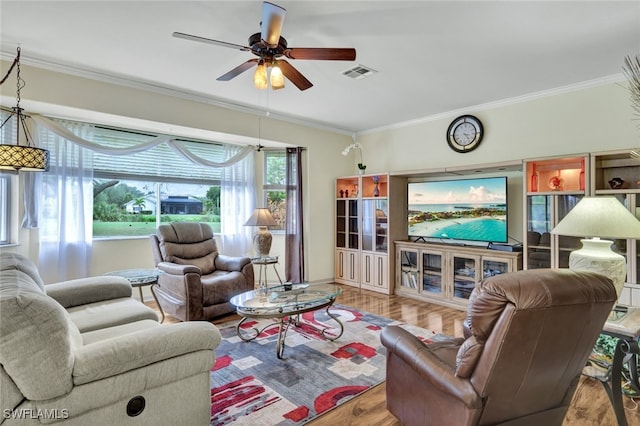 living room with light hardwood / wood-style flooring and crown molding