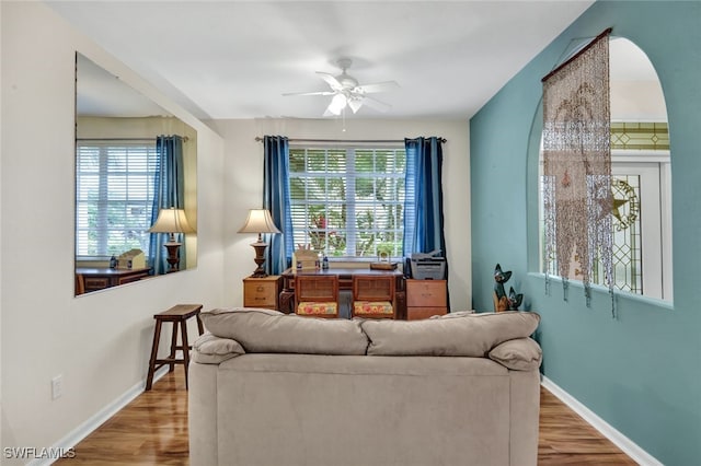 living room with ceiling fan, plenty of natural light, and hardwood / wood-style floors