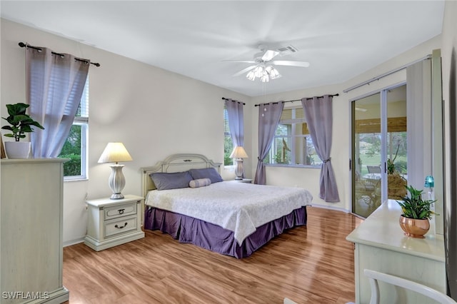 bedroom with ceiling fan, access to exterior, light wood-type flooring, and multiple windows