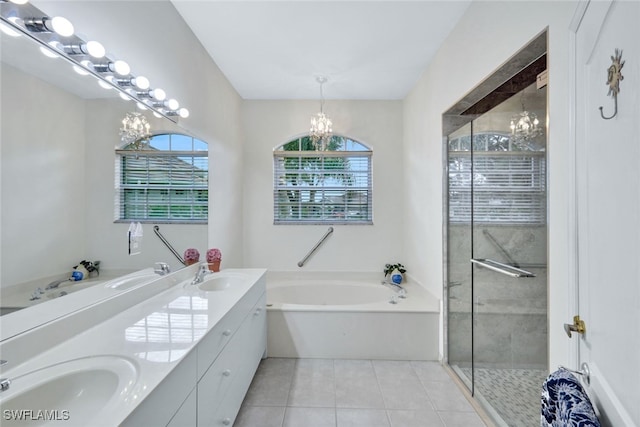 bathroom featuring plus walk in shower, an inviting chandelier, tile patterned floors, and vanity