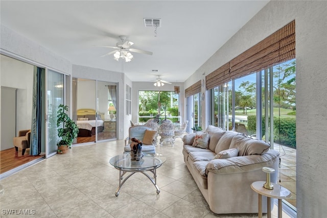 sunroom / solarium featuring ceiling fan