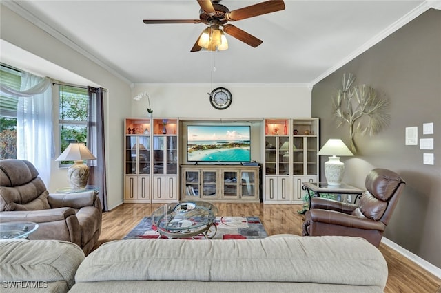 living room with light hardwood / wood-style floors, crown molding, and ceiling fan