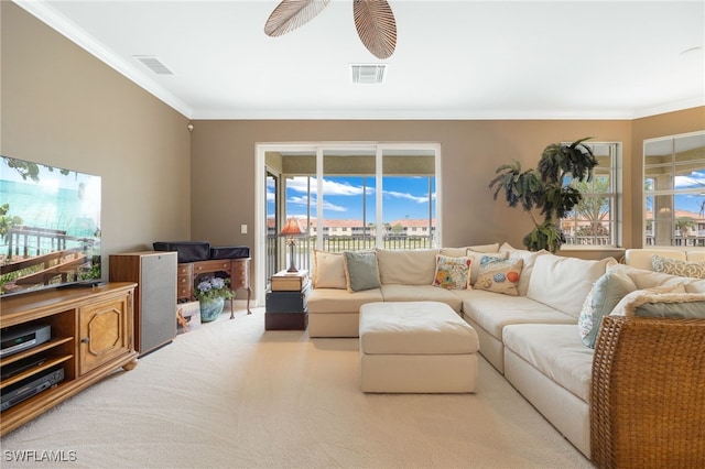 living area with light colored carpet, visible vents, crown molding, and ceiling fan