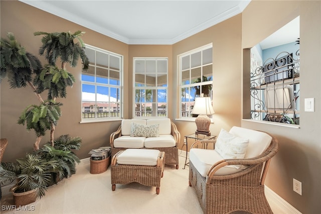 sitting room with carpet floors, baseboards, and ornamental molding