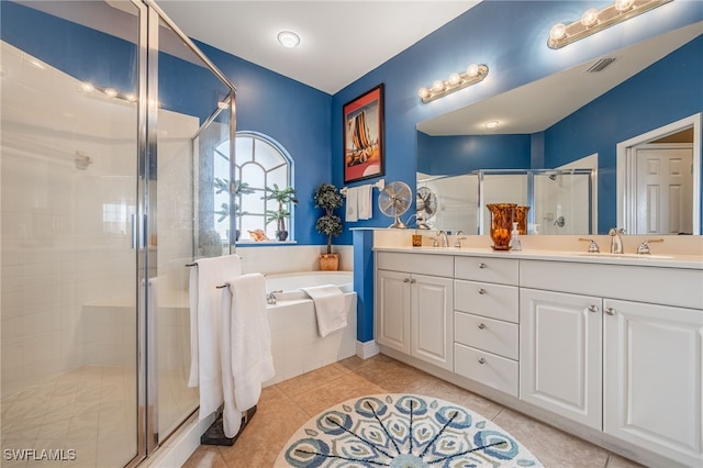 bathroom featuring a stall shower, visible vents, tile patterned floors, a garden tub, and a sink