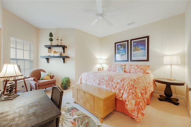 bedroom featuring light carpet, ceiling fan, and baseboards