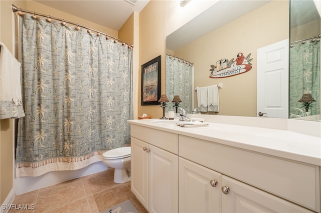 bathroom with toilet, tile patterned flooring, and vanity