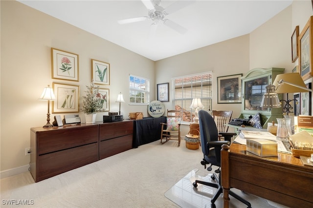 office area featuring a ceiling fan, light colored carpet, and baseboards