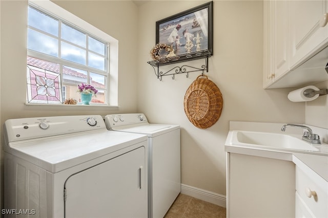 laundry room with baseboards, cabinet space, washing machine and clothes dryer, and light tile patterned floors