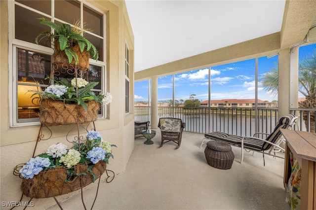 sunroom / solarium with a water view