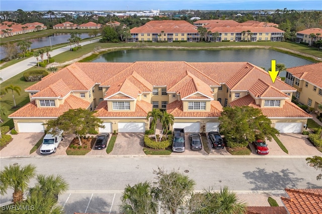 birds eye view of property with a water view and a residential view