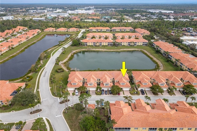 birds eye view of property with a water view and a residential view