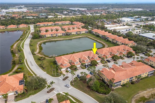 drone / aerial view featuring a water view and a residential view