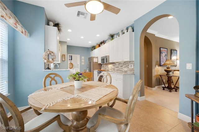 dining space with arched walkways, plenty of natural light, visible vents, and recessed lighting