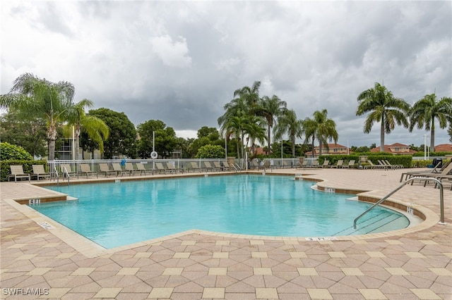 pool featuring a patio area and fence