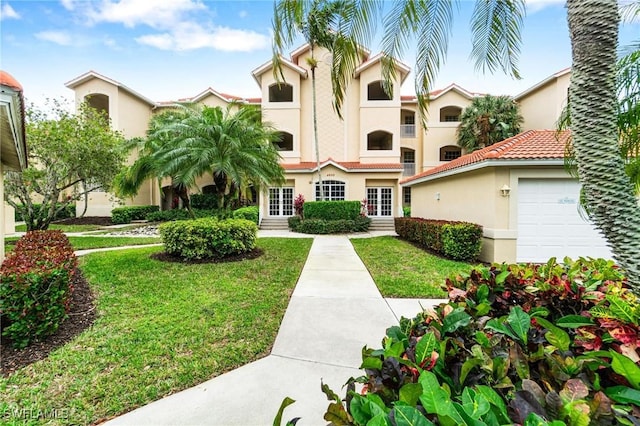 view of front of house featuring a front yard and a garage