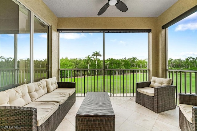 sunroom featuring ceiling fan