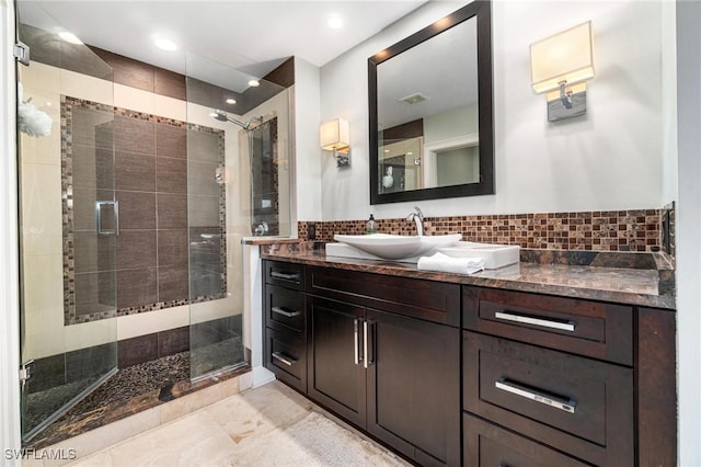 full bathroom with a stall shower, backsplash, and vanity