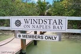 community sign featuring a water view