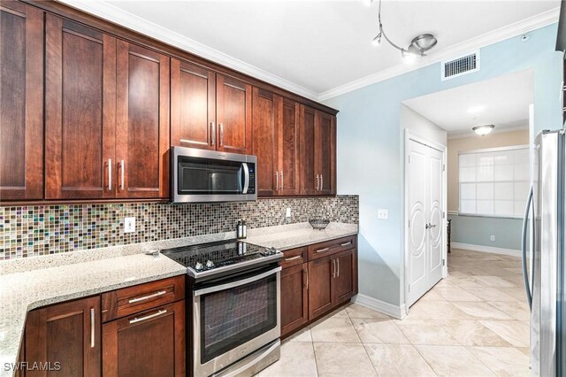 kitchen with stainless steel appliances, light stone countertops, light tile patterned floors, ornamental molding, and backsplash