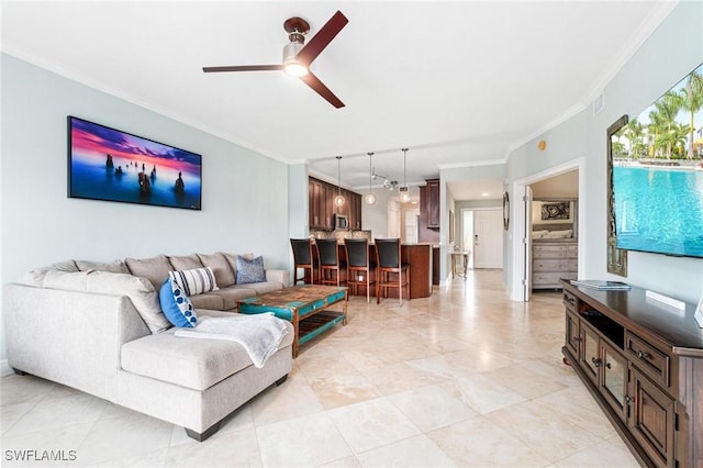 living room with ornamental molding, visible vents, and ceiling fan