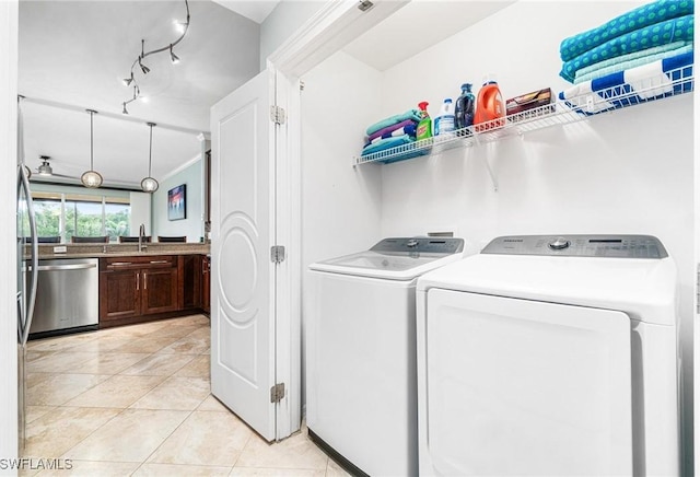 washroom with washer and dryer, light tile patterned flooring, rail lighting, and ornamental molding