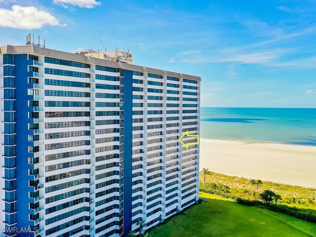 view of building exterior featuring a view of the beach and a water view