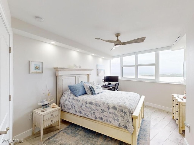 bedroom with ceiling fan and light wood-type flooring