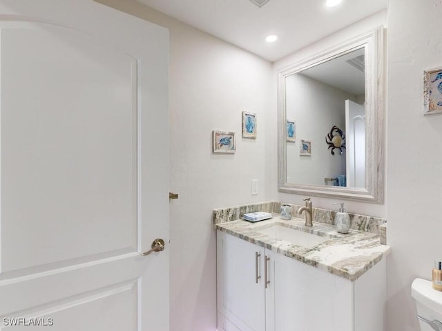 bathroom with toilet and vanity