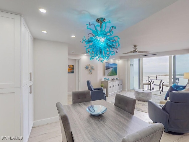 dining room featuring ceiling fan and expansive windows