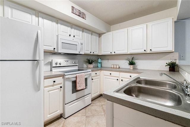 kitchen with white cabinetry, sink, white appliances, and light tile patterned floors