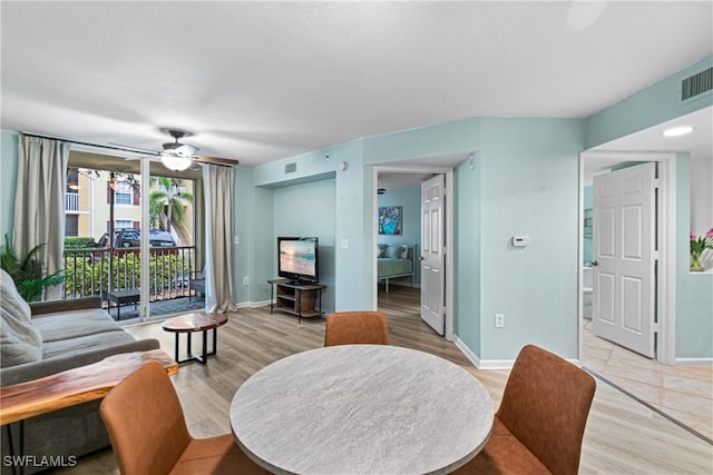 living room featuring ceiling fan and light hardwood / wood-style flooring