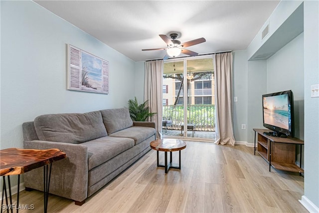 living room featuring light wood-type flooring and ceiling fan