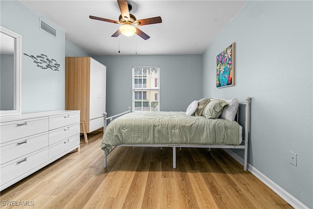 bedroom with light wood-type flooring and ceiling fan