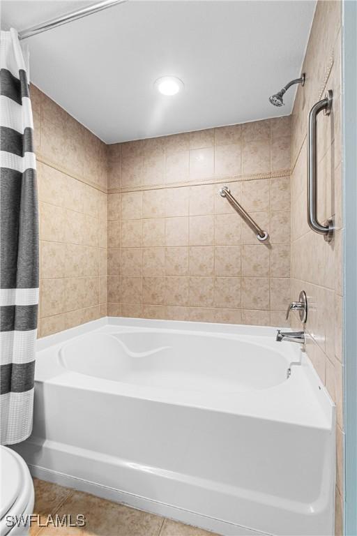 bathroom featuring toilet and shower / bathtub combination with curtain