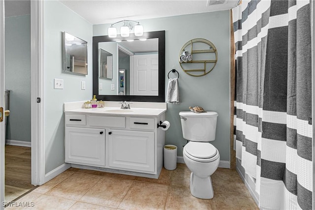 bathroom with tile patterned flooring, curtained shower, toilet, vanity, and a chandelier