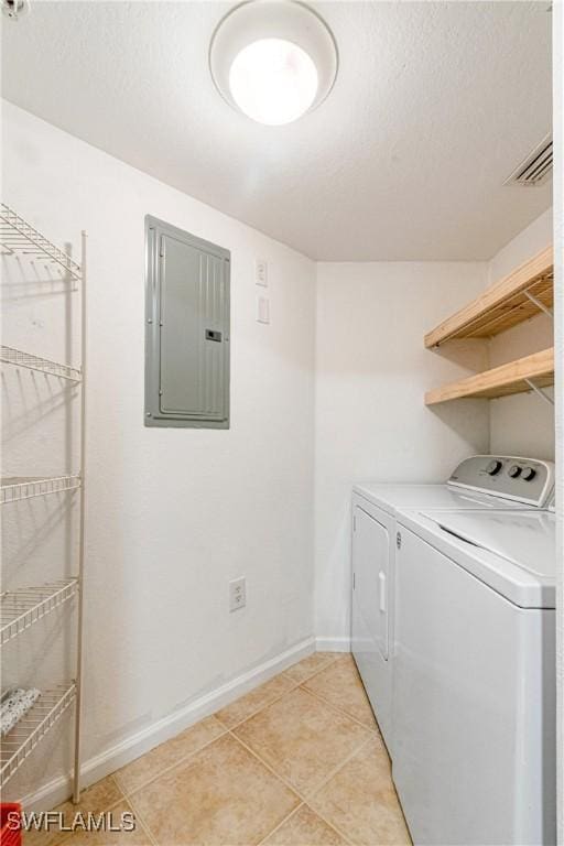 laundry room featuring independent washer and dryer, electric panel, and light tile patterned floors